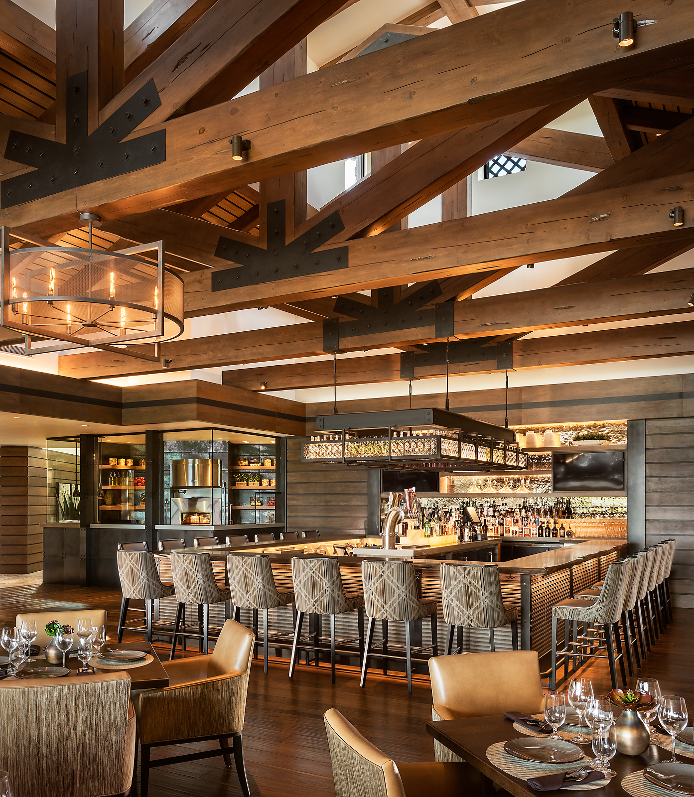 A restaurant with wooden beams and a bar.