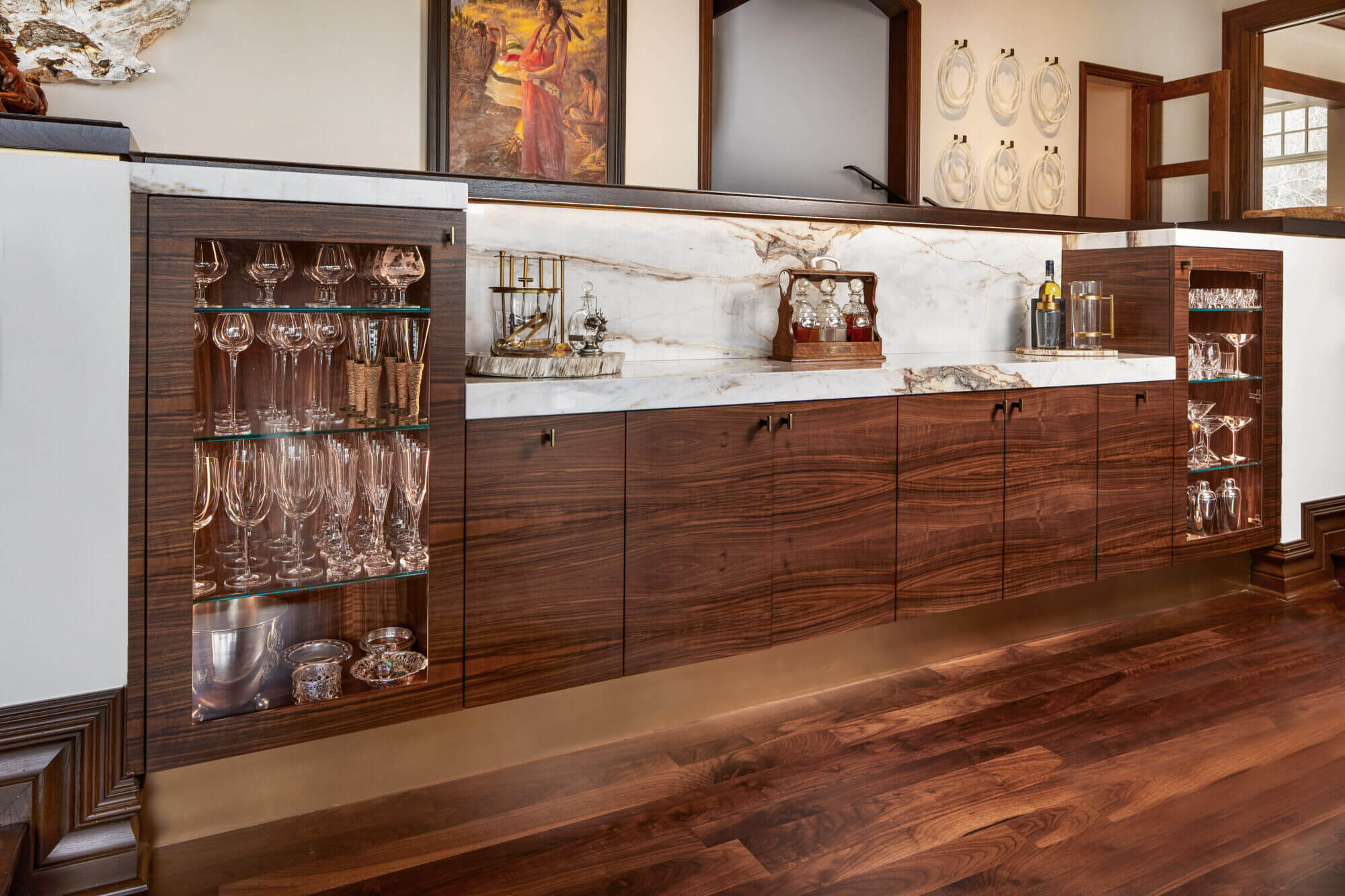 A bar in a kitchen with a wooden floor.