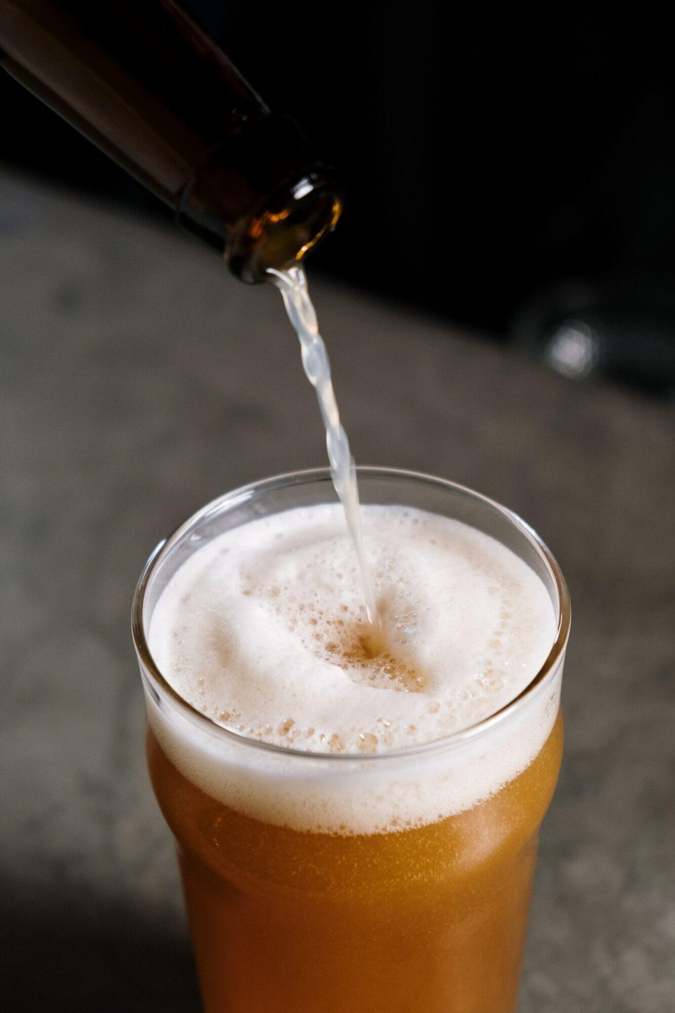 A beer is being poured into a glass.
