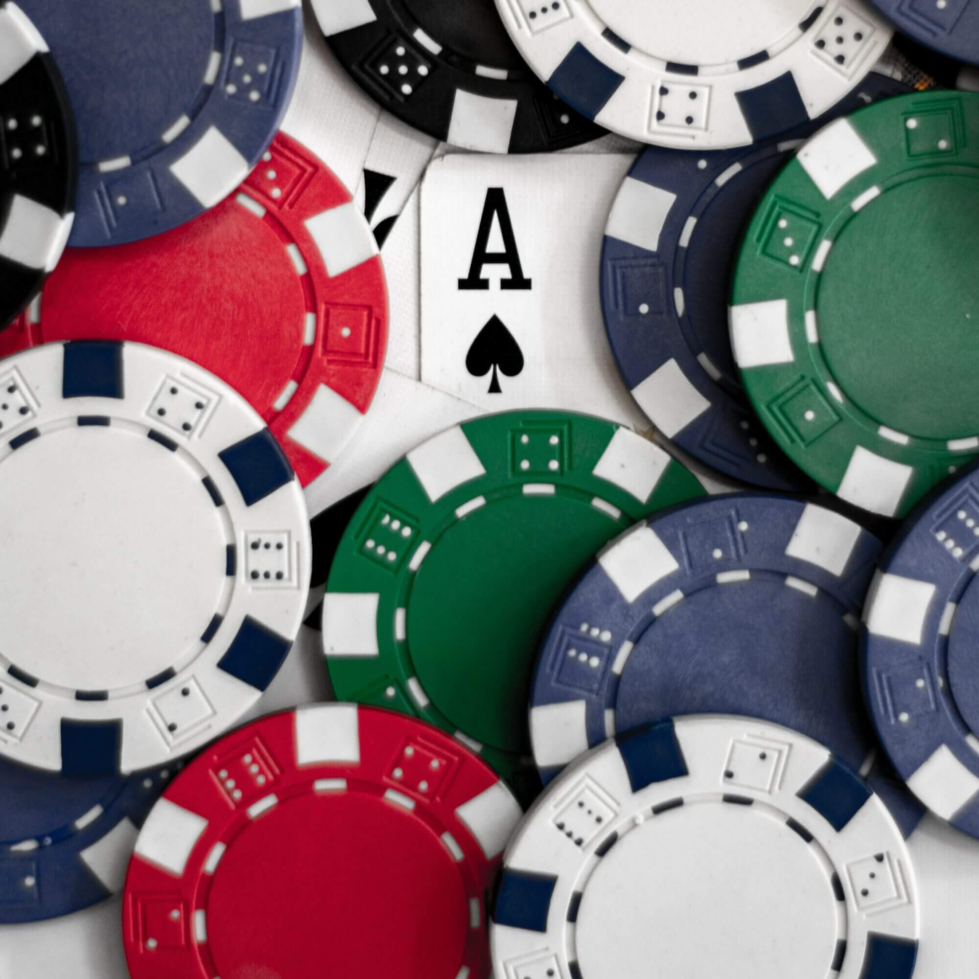 A group of poker chips with an ace in the middle.