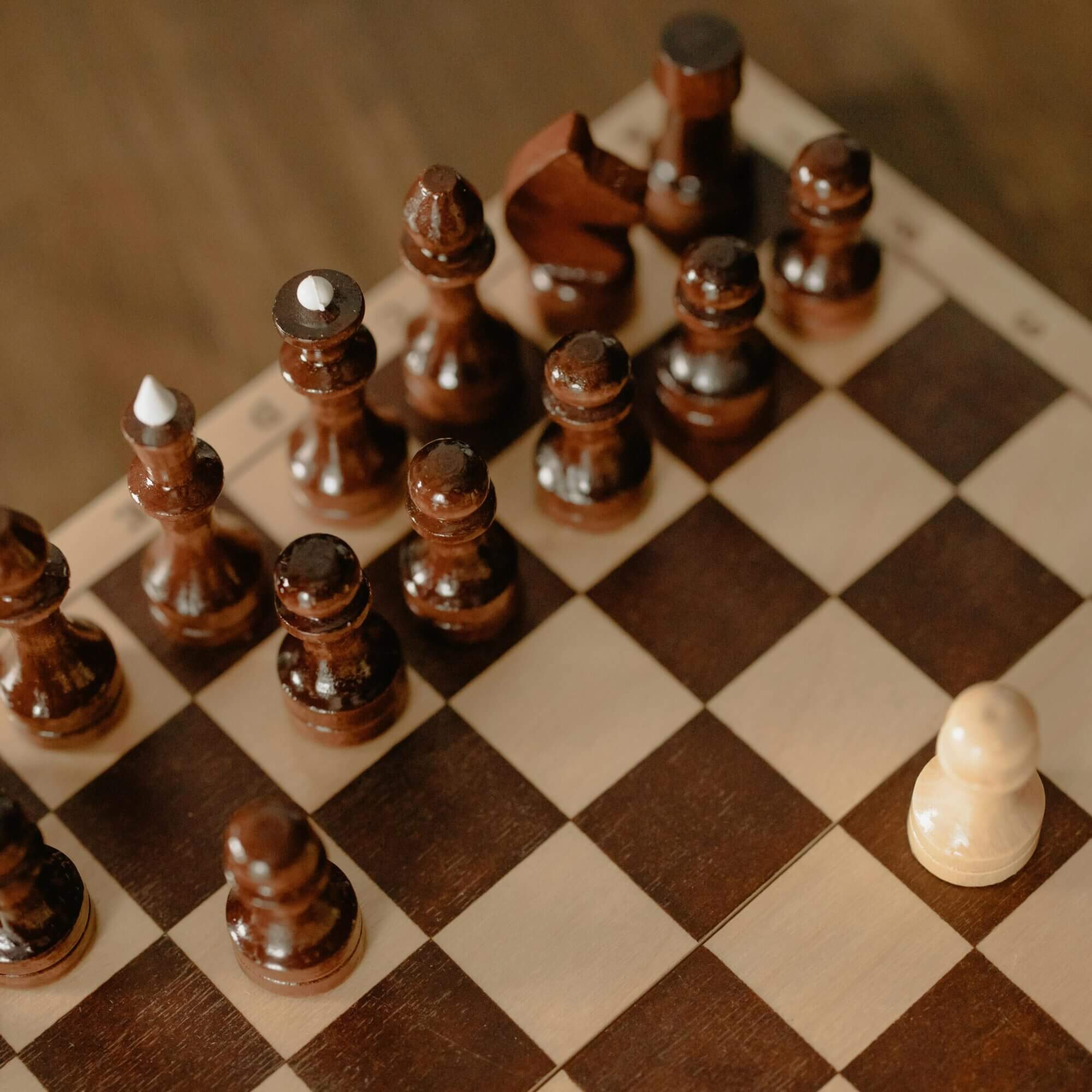 Chess pieces on a wooden chess board.